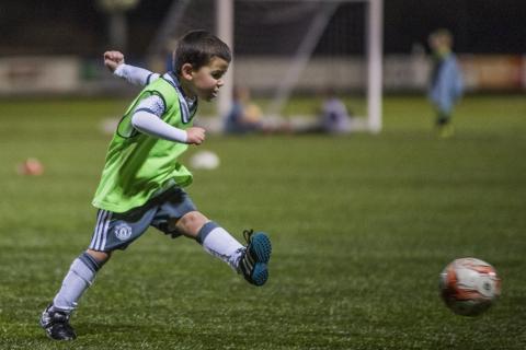 Young child kicking a Football
