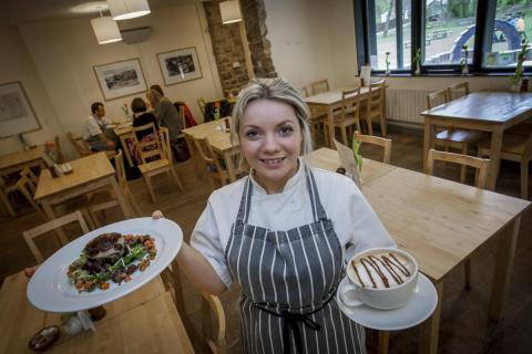 Woman serving food in a cafe