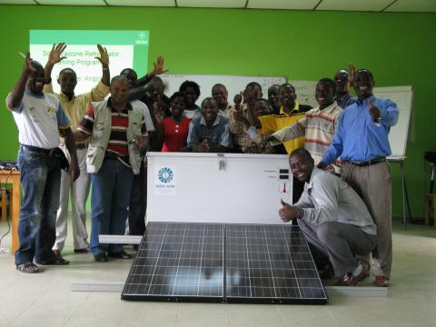 People around a solar panel