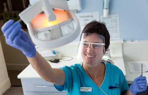 Nurse working a medical machine