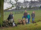 Family stand in field with dogs 