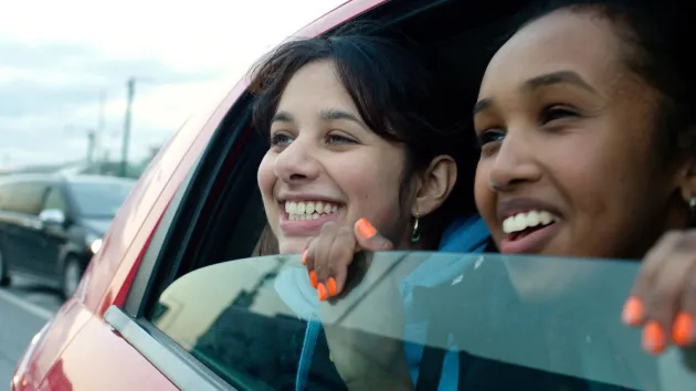 car with 2 girls looking out of the window 