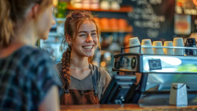 Cafe worker looking at a customer