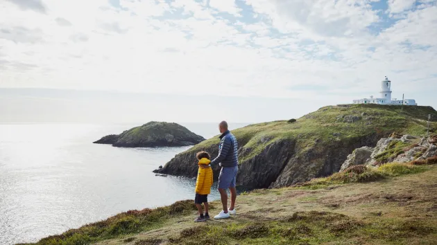 family looking at a lighthouse