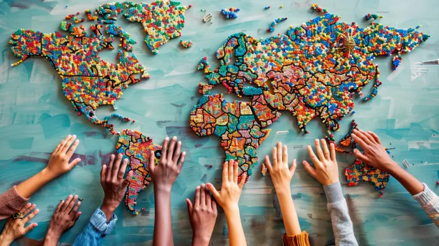 hands touching a map of the world