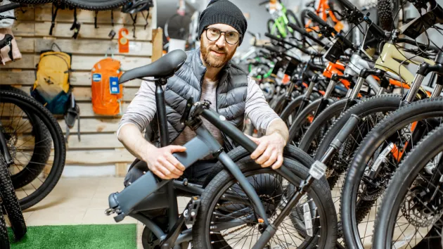 man fixing bikes in shop