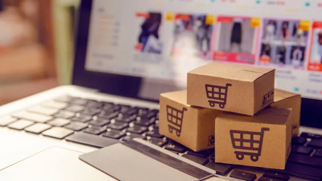 Online shopping - laptop, bank card and small shopping cart