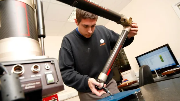 Unimaq staff using a measuring tool - manufacturing