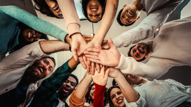 group of volunteers holding hands 