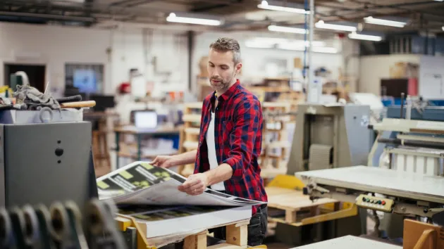 Man working in printing press office 