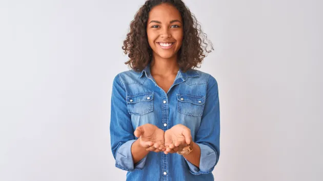 woman with hands extended - giving 