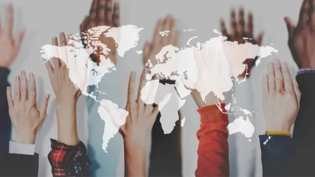 map of the world and different hands 