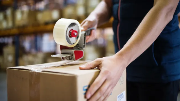 Warehouse worker packing boxes 