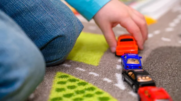 child playing with toy cars 