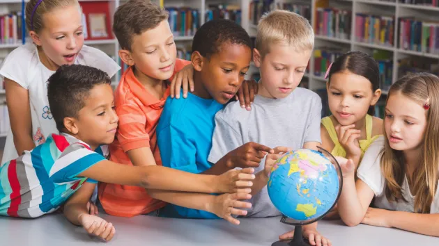 children looking at a map 