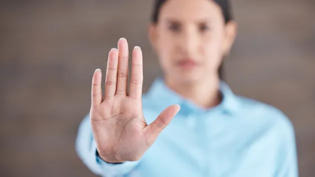 Woman being harassed - hand up to stay top