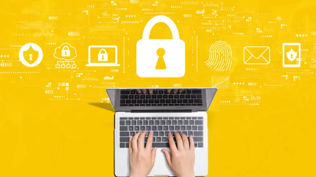 Yellow background, laptop and cyber security digital symbols, padlock, fingerprint