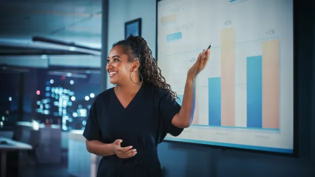 person giving a presentation using graphs