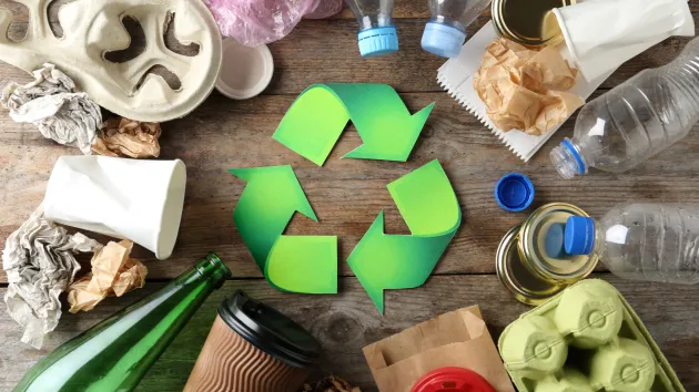Recycling logo and plastic bottles, cardboard
