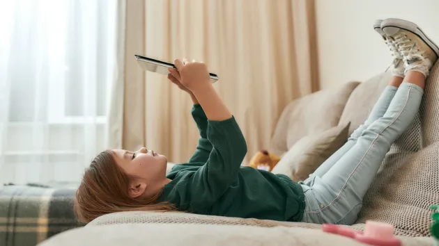 young girl looking at a digital device