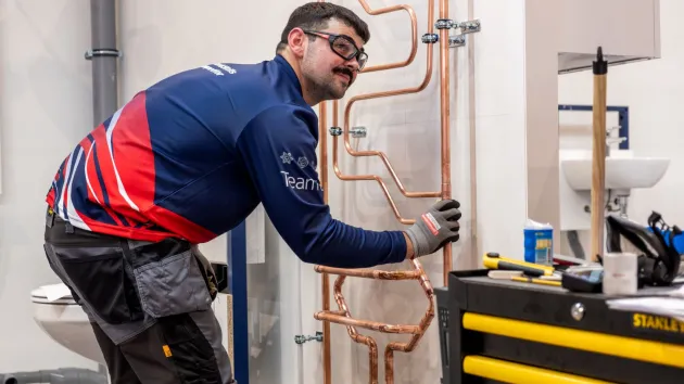 Person competing in a skills competition - plumbing