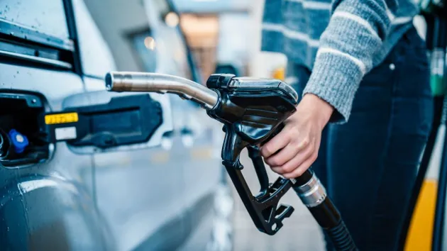 Person putting fuel in their car 