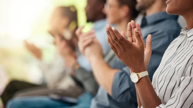 group of people of at a business conference applauding