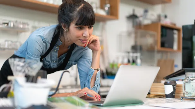 Small business owner looking at a digital device