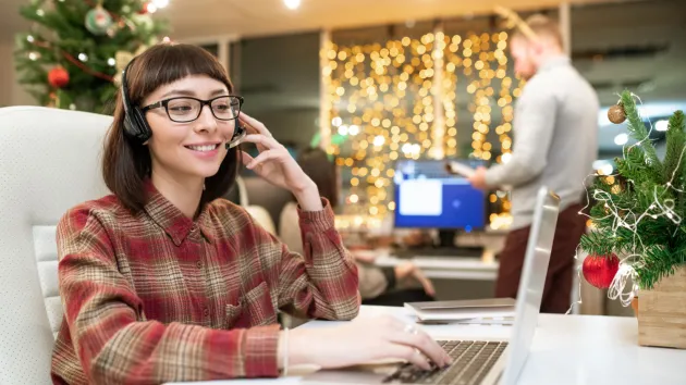 person at work at Christmas using a laptop 