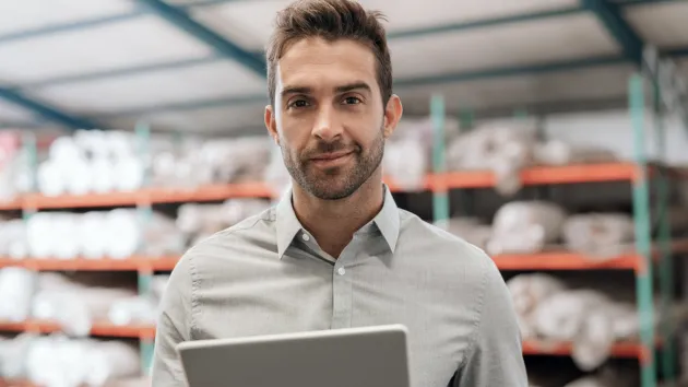 Business owner looking at a digital device 
