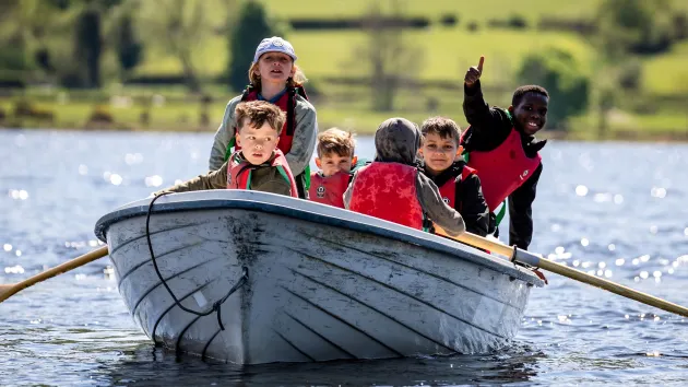 children in a boat at Glan Llyn