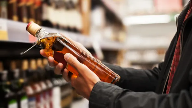 person buying alcohol in a supermarket