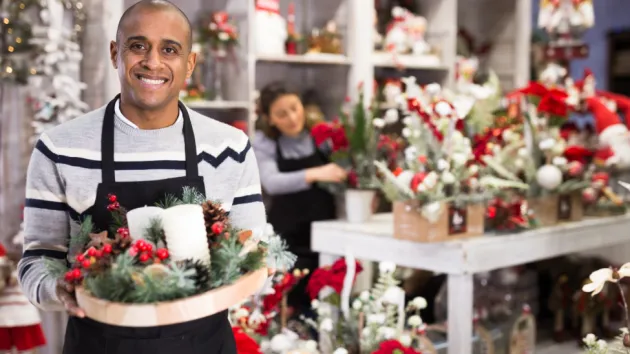 person working in shop selling Christmas goods