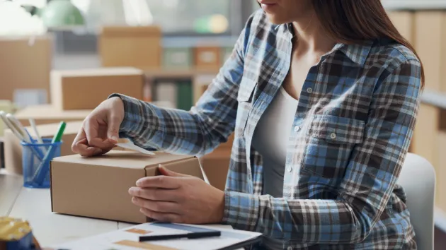 small business owner packaging parcels 