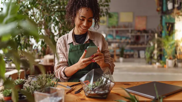 business owner surrounded by plants 