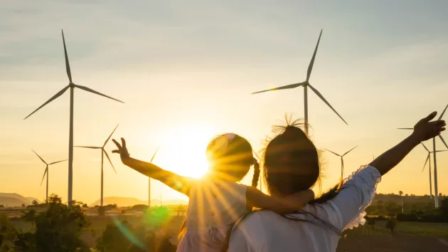 Family looking at wind turbines