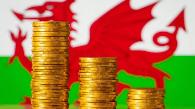Welsh flag and stacks of coins