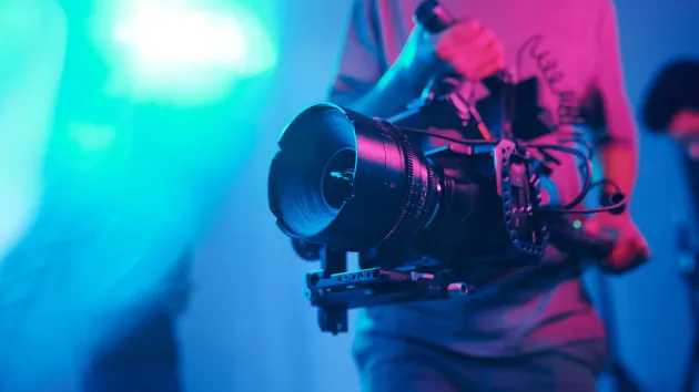 close up of camera and film crew