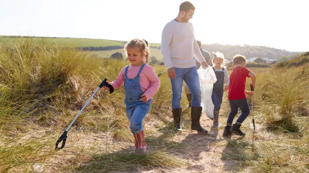 Family litter picking on a beach
