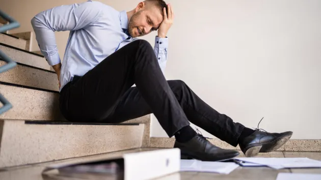 Office worker falling downstairs 