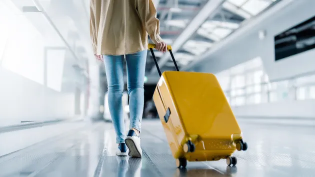 person and suitcase at the airport 