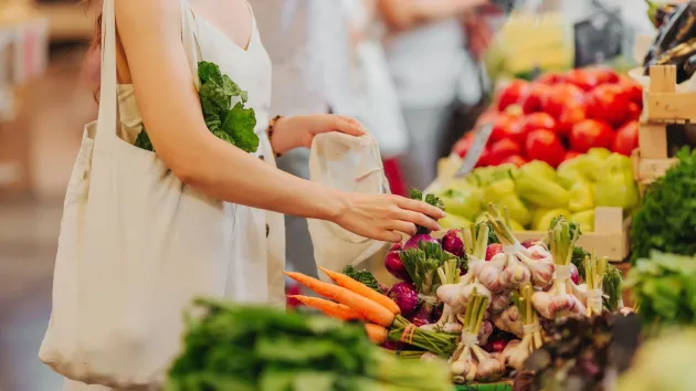 person using a cotton shopping bag for grocery shopping
