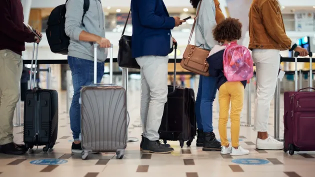 Airport queue, travel and people legs for international vacation, holiday or immigration with suitcase
