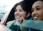 car with 2 girls looking out of the window 