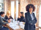 Business woman stood by a desk in an office