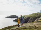 family looking at a lighthouse 