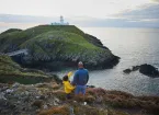 family looking at a lighthouse 