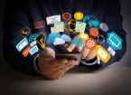 Digital symbols- person using a phone for social media 