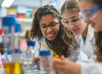 girls in a school science lab working on an experiment 