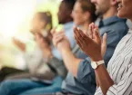 group of people of at a business conference applauding 